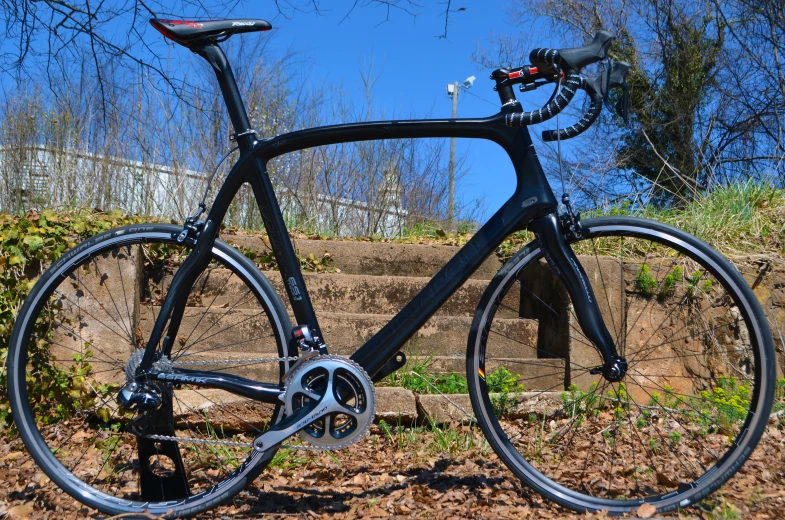 a bike parked on some dirt in the sun