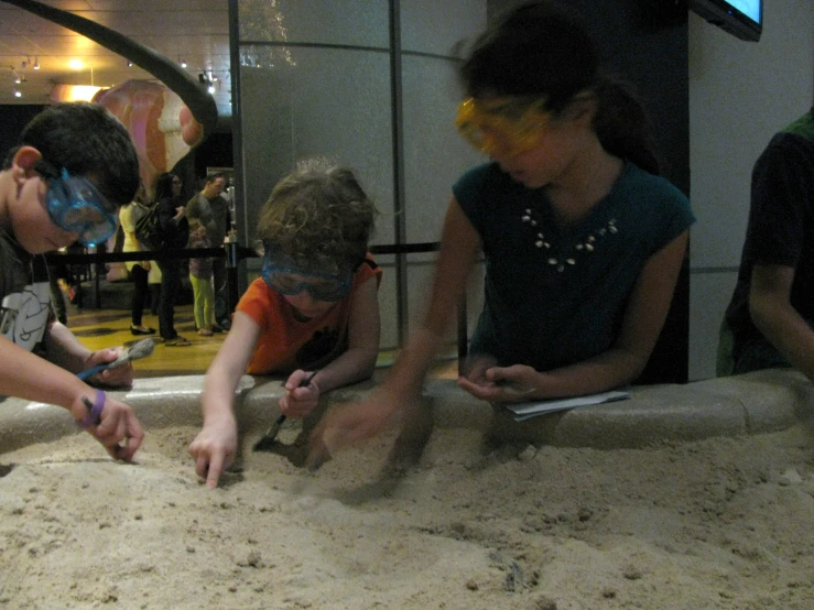 s making sand sculptures in front of a television