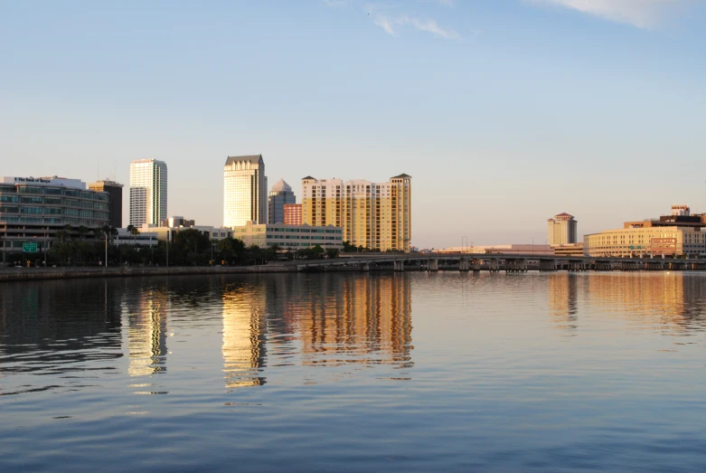 a large body of water with buildings in the background