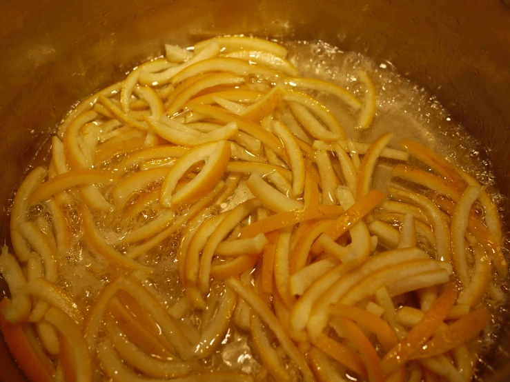 close up image of many noodles in a pan of oil