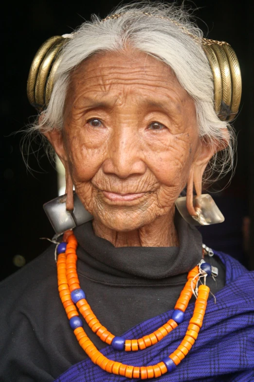 an older woman with some jewelry on her neck