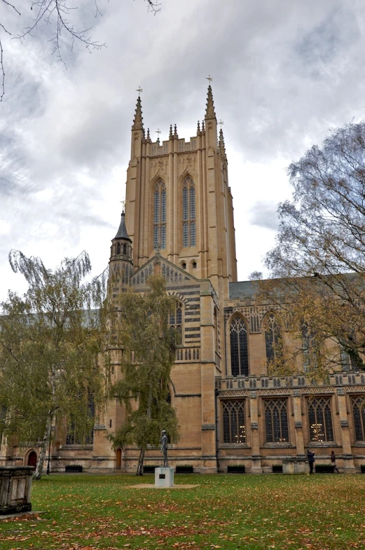 a church with tall towers and green grass