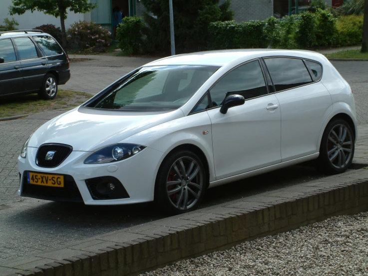 a white car sits parked in front of some cars