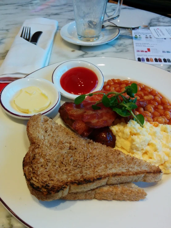 a white plate topped with toast and scrambled eggs