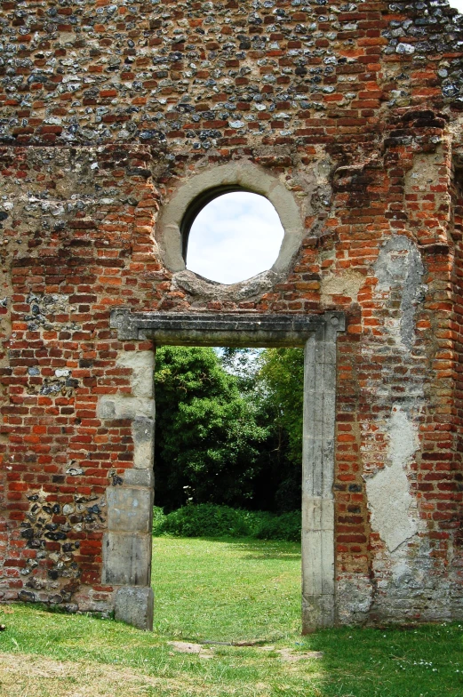 an old brick building with a hole at the center