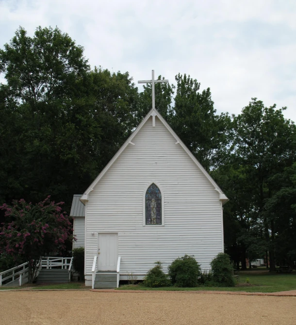 an old church with trees in the background