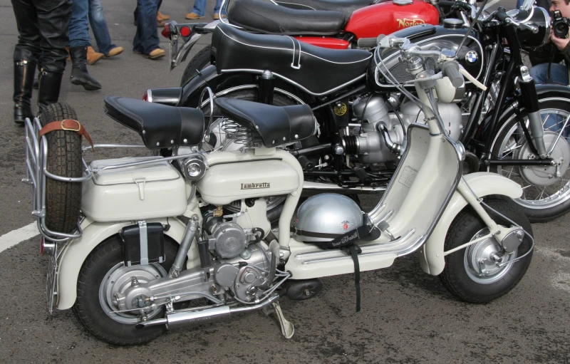 two parked motorcycles sitting on the pavement in a parking lot