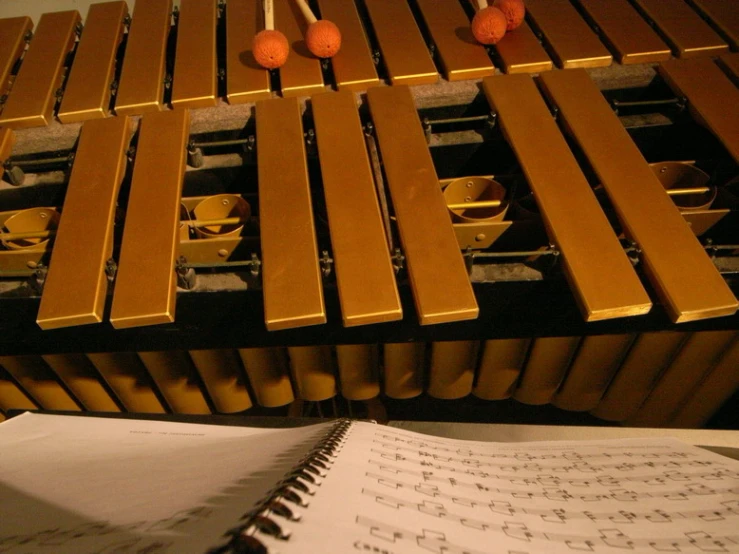 a notepad on a musical instrument and music notes