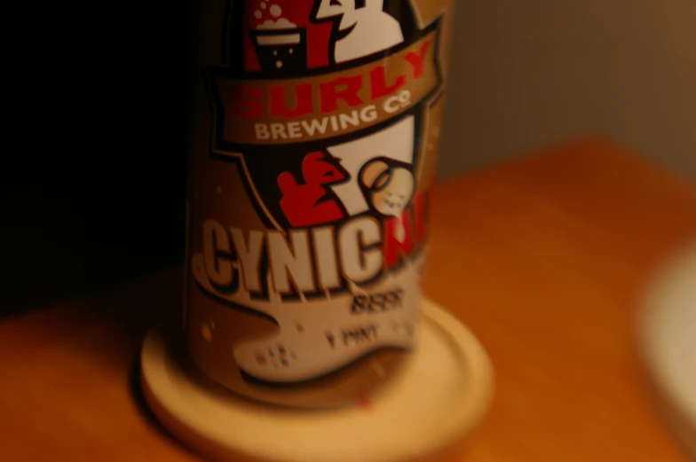 closeup of a bottle of beer sitting on a wooden table