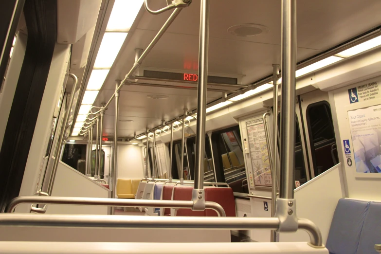 rows of seat are lined up with windows, a rail and no other furniture