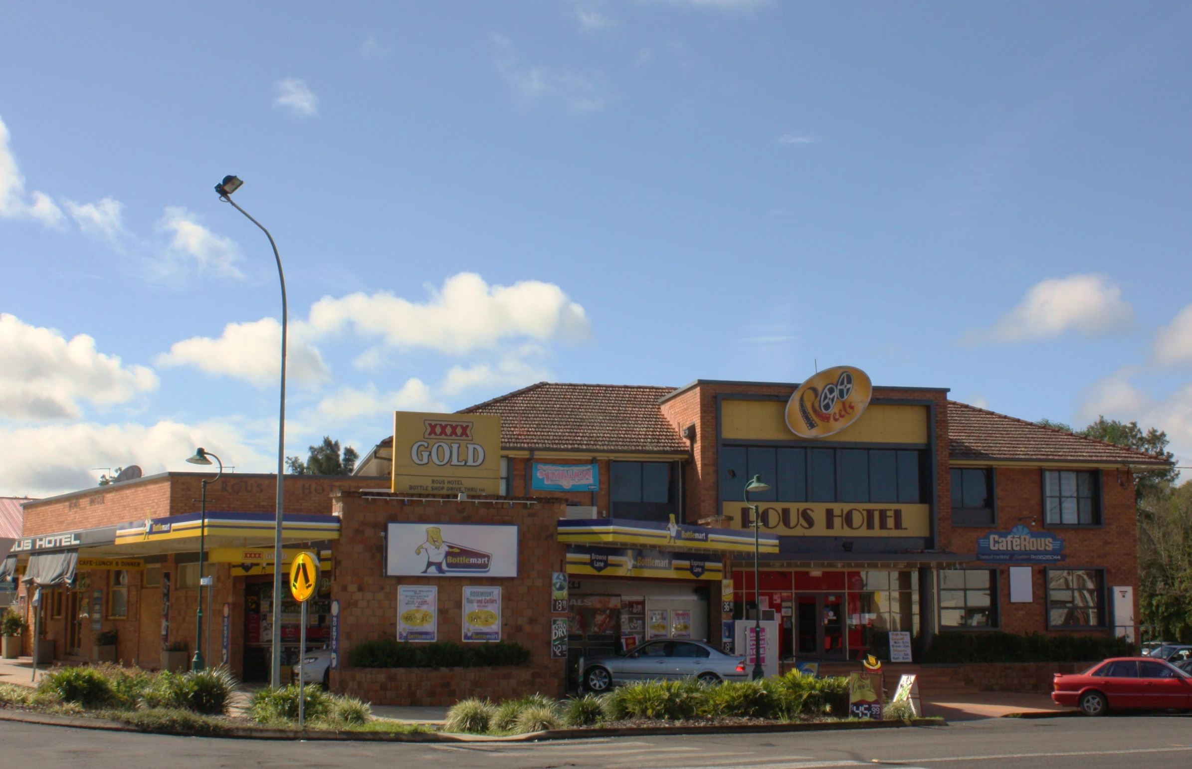 a store with two cars parked in front