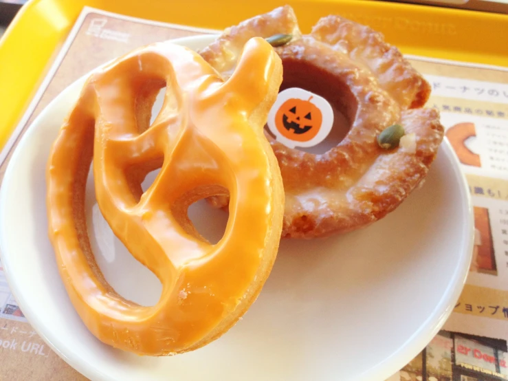 a close up of two donuts on a plate