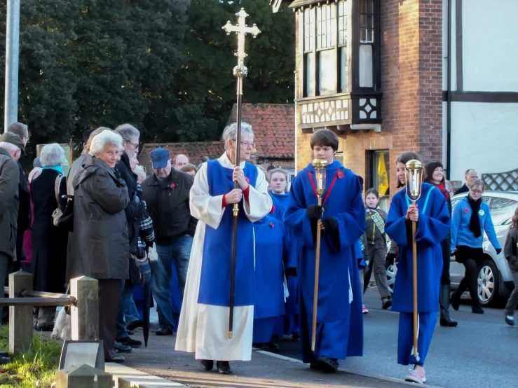 several people wearing blue robes standing at the front of a church