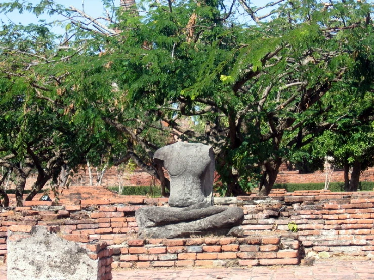 a statue in the middle of brick wall