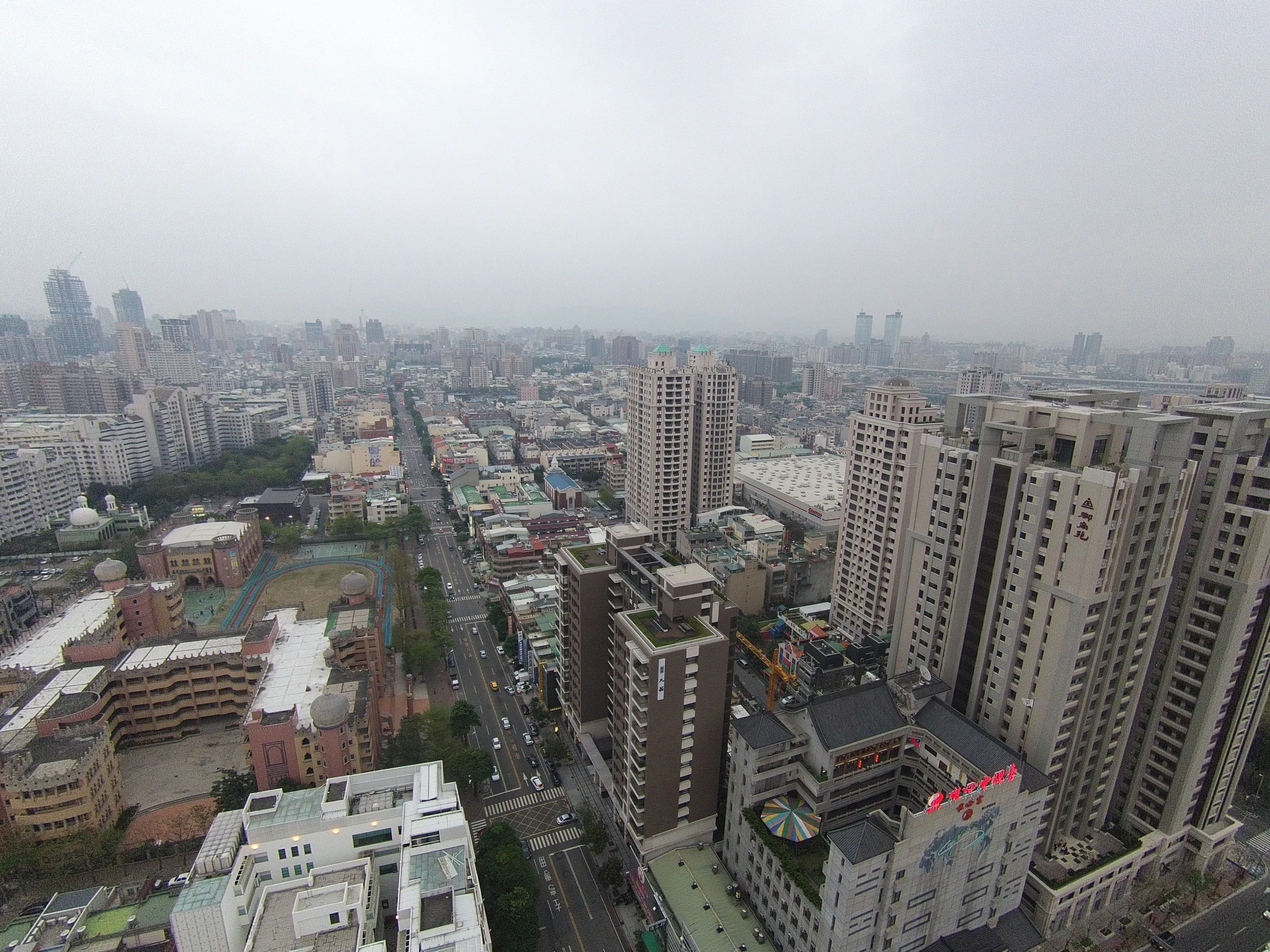 a foggy skyline with tall buildings and a bird eye view