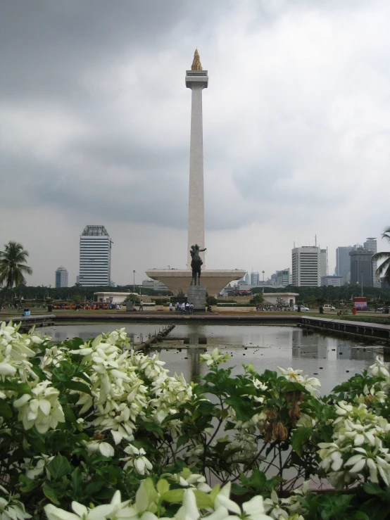 a statue in front of a fountain on a cloudy day