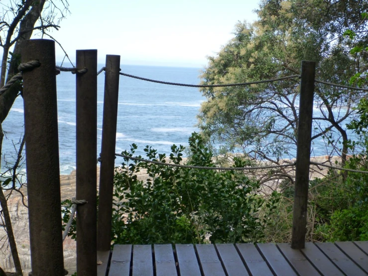 a wooden deck overlooks a wide body of water