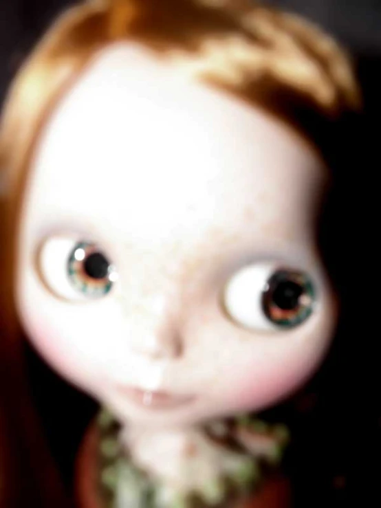 a close up of a doll with big eyes