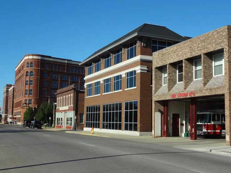 a building on a street corner with red fire trucks