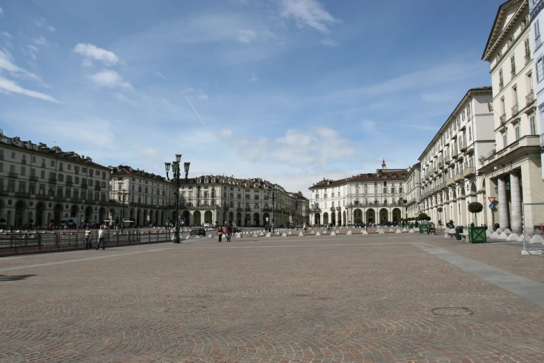 the empty courtyard of a city with a blue sky in the background