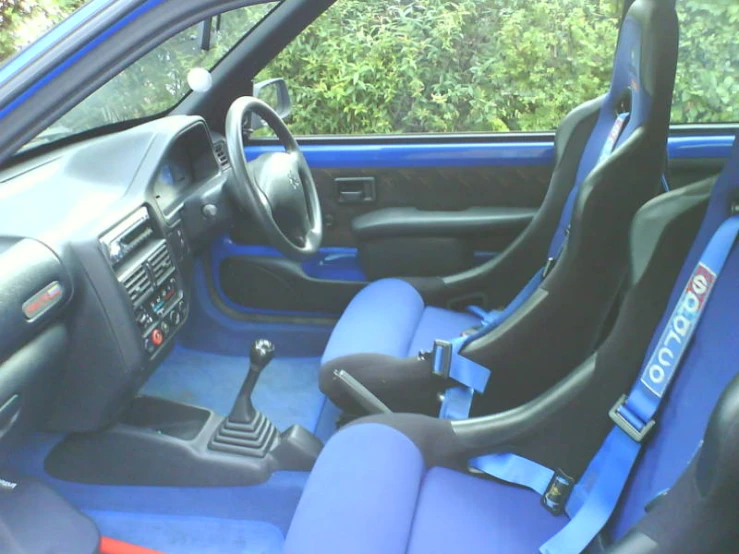 there is a blue and black car interior with the seats up