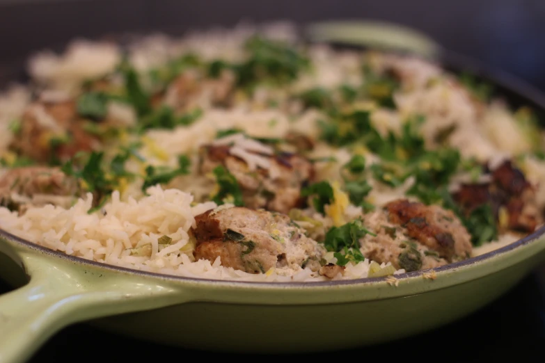 a bowl full of rice and meat in the center