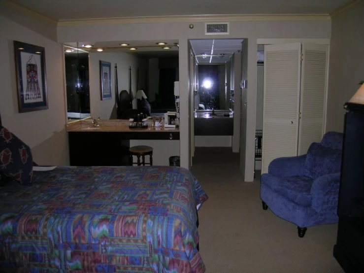 a bedroom with a television and dressing room area