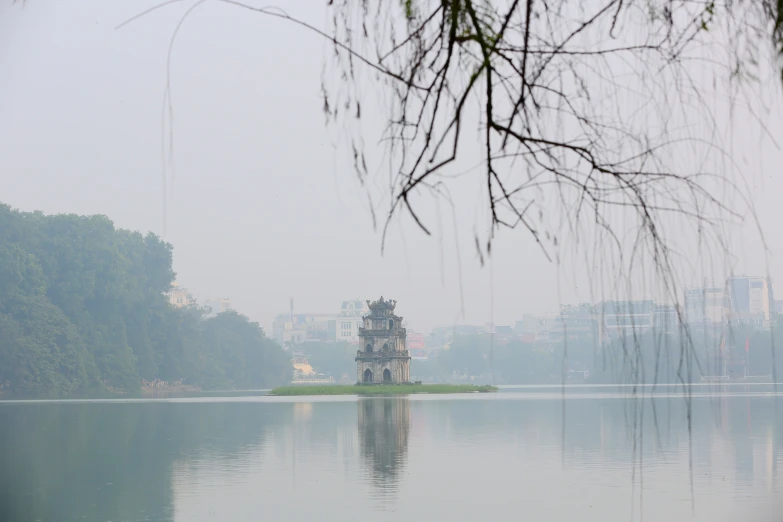 a boat is on the water and buildings on land around