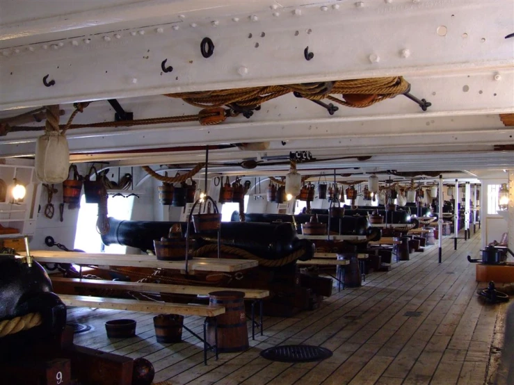 a bunch of tables with various lights hanging off the ceiling