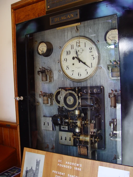 a clock in the wall with its glass display case