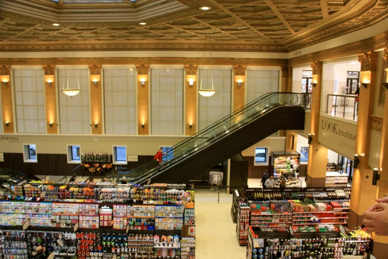the interior of an ornately decorated store has a large escalator