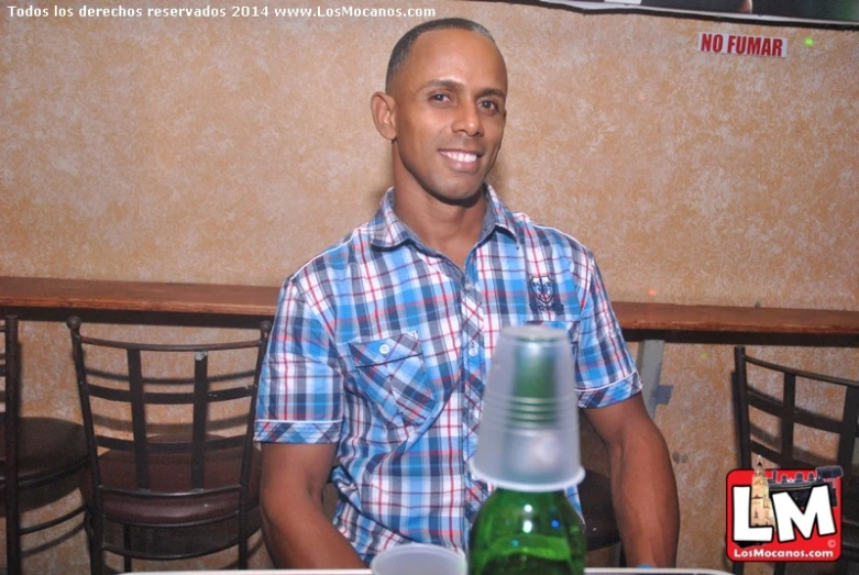 a man sitting at a table in front of some wine bottles