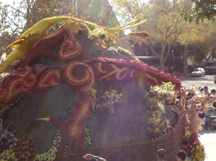 a float decorated with flowers is being ridden