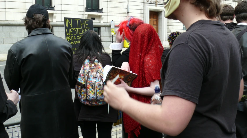 a man in costume stands among a group of people