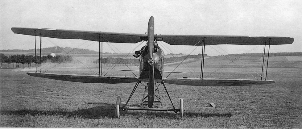 an old pograph of a single - engine air plane sitting on a field