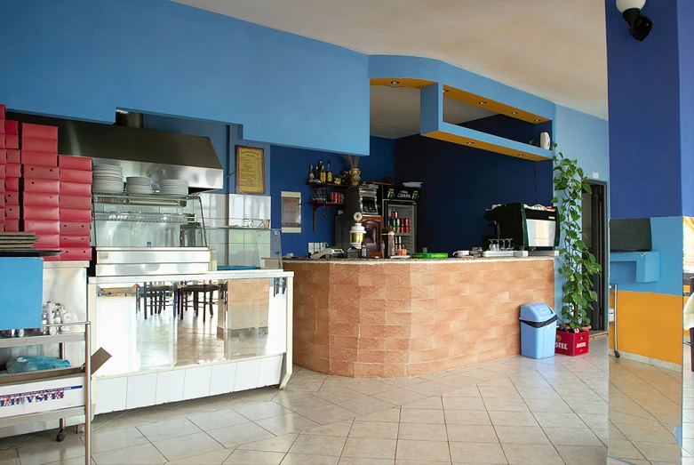 a blue room with a small counter and many different appliances