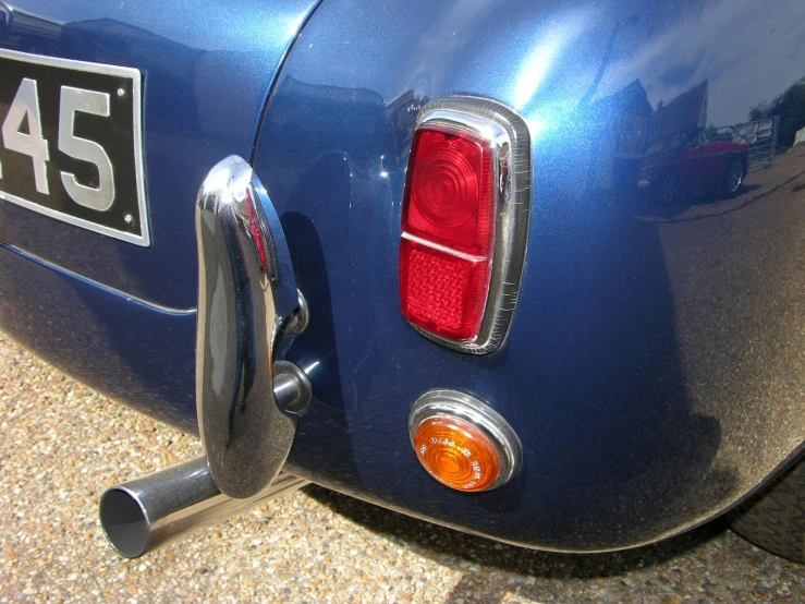 the back end of a blue sports car is shown