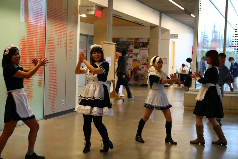 the girls are dressed up and playing in the lobby