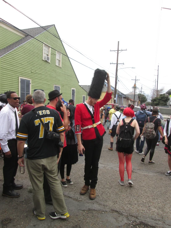 people gather in the street to celete in costume