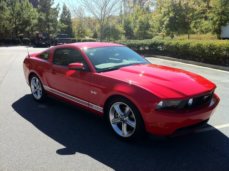 a red sports car is parked on the street