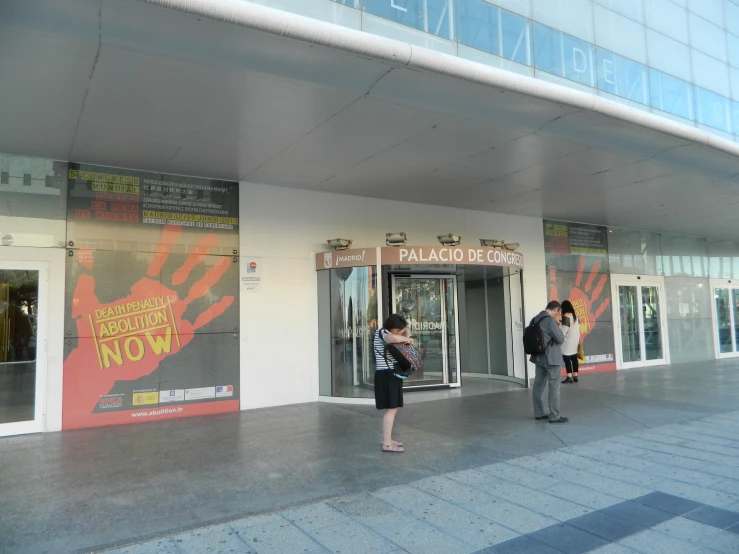 a couple of people standing outside of a building