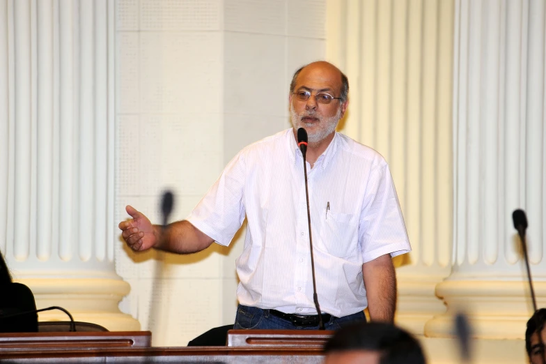 a man with a beard speaking into a microphone