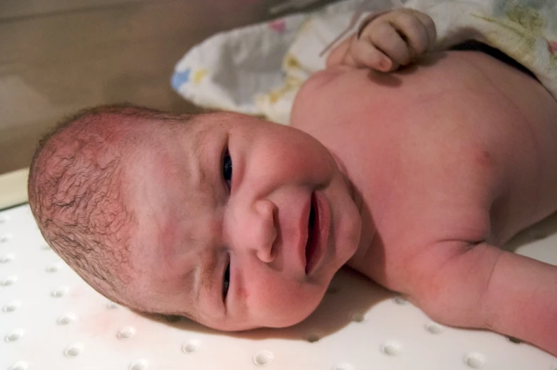 a close up of a baby with a face close to the camera