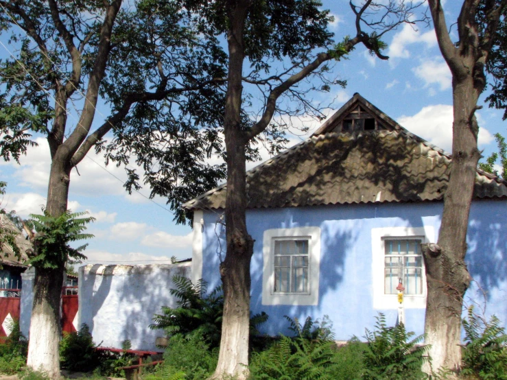 there is a blue building with two windows