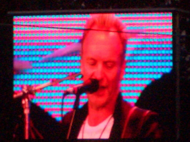 a man playing on a large screen with a microphone