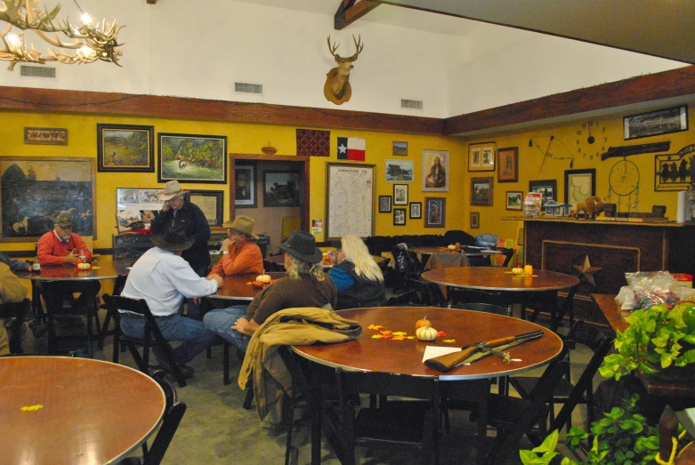 an empty restaurant with tables and people sitting at it