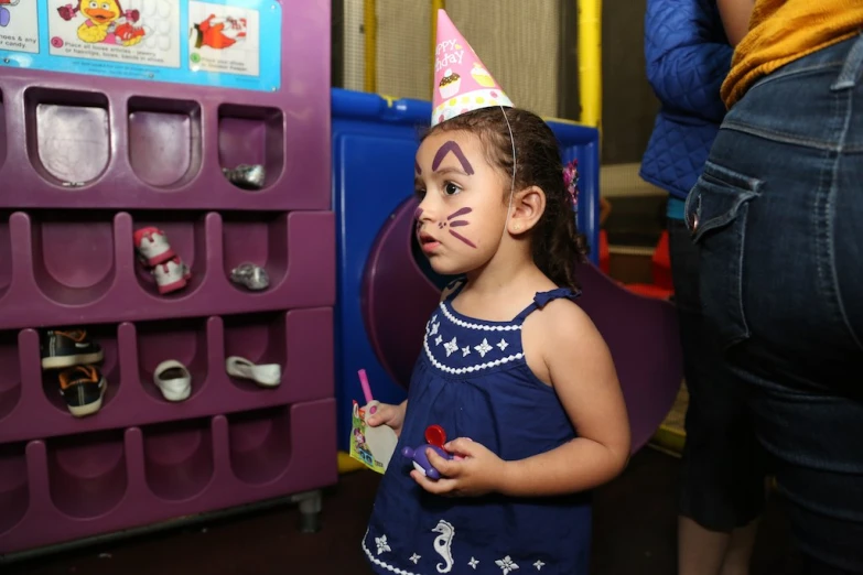  dressed in birthday hat posing for po