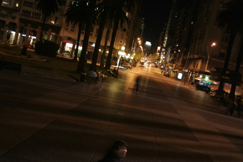 a man walking down a city street at night