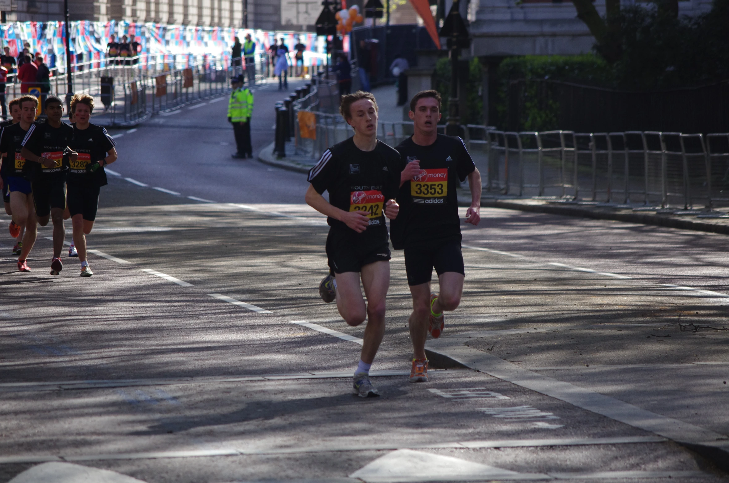 two athletes are running down a city street