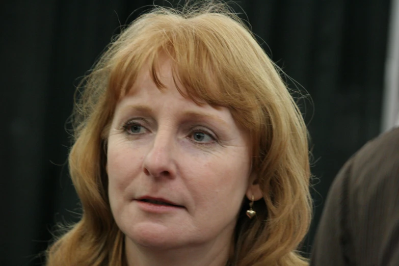 a woman with red hair looking away from the camera